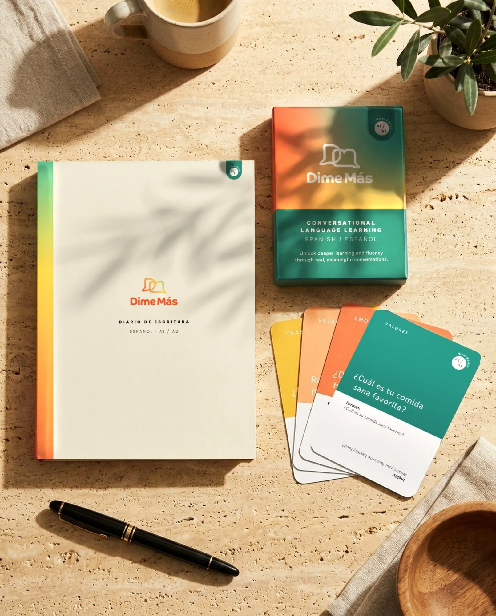 Dime Más beginner cards and journal together, a gift bundle on the table.